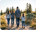 News thumbnail photograph of a family walking away together down a sunlit forest path.