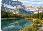 News thumbnail photograph of a turquoise lake, forest, and dramatic snow-covered mountain range.